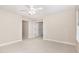 Open bedroom with neutral carpet, ceiling fan, and door to access hallway at 1304 Barnford Mill Rd, Wake Forest, NC 27587