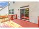 Home's back deck features a sliding glass door, railings, and light-colored siding at 1304 Barnford Mill Rd, Wake Forest, NC 27587