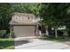 Charming two-story home with a stone facade, attached garage, and well-manicured front yard at 1304 Barnford Mill Rd, Wake Forest, NC 27587
