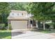 Charming two-story home with a stone facade, attached garage, and well-manicured front yard at 1304 Barnford Mill Rd, Wake Forest, NC 27587