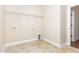 Functional laundry room with tiled floors, utility connections, and ample storage space at 1304 Barnford Mill Rd, Wake Forest, NC 27587