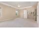 Bright main bedroom boasts neutral carpet, tray ceiling, and access to additional rooms at 1304 Barnford Mill Rd, Wake Forest, NC 27587