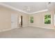 Spacious main bedroom with neutral carpet, tray ceiling, and bright windows at 1304 Barnford Mill Rd, Wake Forest, NC 27587