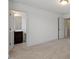 Bedroom featuring an en-suite bathroom and an open doorway to a hallway beyond at 140 Token House Rd, Durham, NC 27703