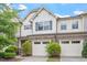 Charming exterior of a townhome featuring a two-car garage, stone accents, and tidy landscaping at 140 Token House Rd, Durham, NC 27703