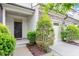 Entrance view of a townhome featuring well maintained landscaping, covered entrance, and a two car garage at 140 Token House Rd, Durham, NC 27703