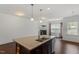 Spacious kitchen with granite island, stainless steel dishwasher, and dark cabinets at 140 Token House Rd, Durham, NC 27703