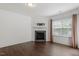 Bright living room features a fireplace, large windows, and sleek hardwood floors at 140 Token House Rd, Durham, NC 27703