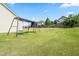 Large backyard with a swing set, offering plenty of space for children to play and enjoy the outdoors at 1400 Manley Ct, Fuquay Varina, NC 27526