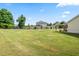 Expansive backyard featuring a well-maintained lawn, wooden fence and patio at 1400 Manley Ct, Fuquay Varina, NC 27526