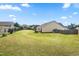 Large backyard with lush lawn, mature trees, wooden fence, and ample space for outdoor activities at 1400 Manley Ct, Fuquay Varina, NC 27526