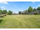 Spacious backyard with a well-manicured lawn, wooden fence, and a covered patio area for entertaining at 1400 Manley Ct, Fuquay Varina, NC 27526