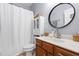 Charming bathroom features a decorative round mirror, storage, and a toilet at 1400 Manley Ct, Fuquay Varina, NC 27526