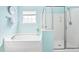 Bright bathroom with a soaking tub and a glass shower enclosure at 1400 Manley Ct, Fuquay Varina, NC 27526