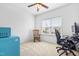 Guest bedroom features a vintage rocker, desk, and a ceiling fan at 1400 Manley Ct, Fuquay Varina, NC 27526