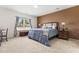 Well-lit bedroom with a cozy bed, neutral carpet and natural light from a bright window at 1400 Manley Ct, Fuquay Varina, NC 27526