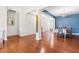 Dining room with hardwood floors, a blue accent wall, and a table set for a meal at 1400 Manley Ct, Fuquay Varina, NC 27526