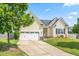 Attractive single-Gathering home featuring an attached two-car garage, driveway, and lush green lawn at 1400 Manley Ct, Fuquay Varina, NC 27526