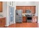 This kitchen features stainless steel appliances, granite countertops, and a pantry with a decorative door at 1400 Manley Ct, Fuquay Varina, NC 27526