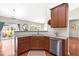 This kitchen features dark wood cabinets, granite countertops, and stainless steel appliances at 1400 Manley Ct, Fuquay Varina, NC 27526