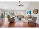 Bright living room with hardwood floors, a large sectional sofa, and a view of the backyard at 1400 Manley Ct, Fuquay Varina, NC 27526