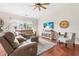 Cozy living room features a sectional sofa, ceiling fan, and a flat screen television at 1400 Manley Ct, Fuquay Varina, NC 27526