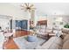 Open-concept living room with hardwood floors, a sectional sofa, and easy access to the dining area at 1400 Manley Ct, Fuquay Varina, NC 27526