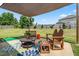Outdoor seating area with bench, chairs, an overhead covering, and spacious backyard at 1400 Manley Ct, Fuquay Varina, NC 27526