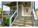 Stairs up to the home's back porch and sliding glass door, with a ceiling fan overhead at 1410 Joe Louis Ave, Raleigh, NC 27610