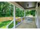 Cozy outdoor living featuring a wood deck and backyard views at 1410 Joe Louis Ave, Raleigh, NC 27610