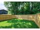 Large, flat backyard featuring a beautiful lawn and a wood privacy fence at 1410 Joe Louis Ave, Raleigh, NC 27610