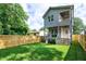 This backyard features a double deck and a large green lawn at 1410 Joe Louis Ave, Raleigh, NC 27610