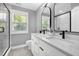 Modern bathroom featuring double sinks, quartz countertop, and a glass enclosed shower at 1410 Joe Louis Ave, Raleigh, NC 27610