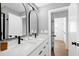 Bathroom with double sinks, quartz countertop, modern fixtures, and arched mirrors at 1410 Joe Louis Ave, Raleigh, NC 27610