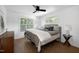 Bright bedroom featuring a large window, ceiling fan, and stylish decor at 1410 Joe Louis Ave, Raleigh, NC 27610