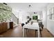 Bright dining area with leaf-patterned wallpaper adjacent to a wooden staircase at 1410 Joe Louis Ave, Raleigh, NC 27610
