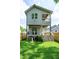 The back exterior of this home features a double deck and a large green lawn at 1410 Joe Louis Ave, Raleigh, NC 27610