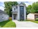 Charming two-story home featuring modern architectural design, concrete driveway, and well-maintained lawn at 1410 Joe Louis Ave, Raleigh, NC 27610