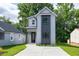 Charming two-story home featuring modern architectural design, concrete driveway, and well-maintained lawn at 1410 Joe Louis Ave, Raleigh, NC 27610