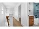 Bright hallway leading to a bathroom with blue tile accents and modern fixtures at 1410 Joe Louis Ave, Raleigh, NC 27610