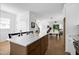 Bright kitchen with stainless steel appliances, wood cabinets, and a spacious quartz countertop island at 1410 Joe Louis Ave, Raleigh, NC 27610