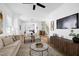 Bright living room with a neutral color palette, modern furniture, and view to the kitchen at 1410 Joe Louis Ave, Raleigh, NC 27610