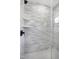 Modern shower with tiled walls, glass door, and built-in shelving at 1410 Joe Louis Ave, Raleigh, NC 27610