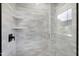 Modern shower with tiled walls, glass door, and built-in shelving at 1410 Joe Louis Ave, Raleigh, NC 27610