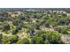 Aerial view of the community featuring homes, streets, and mature trees with overhead utility infrastructure at 1442 Morningside Dr, Burlington, NC 27217