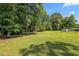 Beautiful, sprawling backyard with mature trees providing ample shade at 1442 Morningside Dr, Burlington, NC 27217