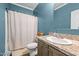 A blue bathroom with a shower/tub combination and a single sink vanity at 1442 Morningside Dr, Burlington, NC 27217