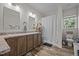 Bathroom with double sinks, wood cabinets, shower and tub combination at 1442 Morningside Dr, Burlington, NC 27217