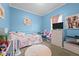 A cute bedroom with blue walls, white furniture, and a small play area at 1442 Morningside Dr, Burlington, NC 27217
