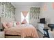 Bedroom featuring a queen bed, pink bedding, TV, window and decorative wall vines at 1442 Morningside Dr, Burlington, NC 27217